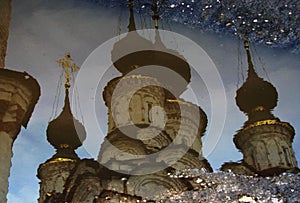 A vintage look at a wintery puddle in Russia and a white Orthodox church